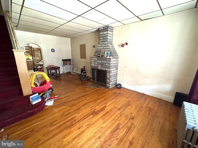 2072 Pickwick St, Philadelphia, PA 19134 - living room featuring wood finished floors, a paneled ceiling, and a large fireplace