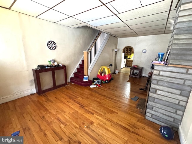 2072 Pickwick St, Philadelphia, PA 19134 - basement featuring arched walkways, stairs, wood finished floors, and a paneled ceiling