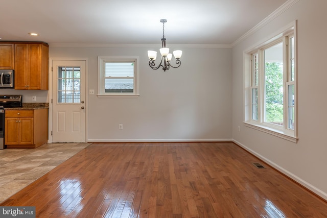 10311 Poe Dr, Manassas, VA 20110 - unfurnished dining area with a chandelier, healthy amount of natural light, light wood-style flooring, and ornamental molding