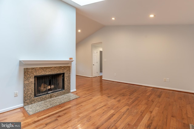 10311 Poe Dr, Manassas, VA 20110 - unfurnished living room with recessed lighting, lofted ceiling, wood finished floors, and a premium fireplace