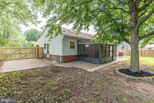 10311 Poe Dr, Manassas, VA 20110 - rear view of house featuring a sunroom, a gate, and a patio