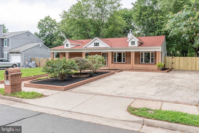 10311 Poe Dr, Manassas, VA 20110 - view of front facade with brick siding, driveway, covered porch, and a chimney