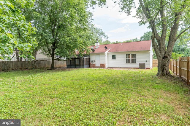 10311 Poe Dr, Manassas, VA 20110 - rear view of property with a sunroom, a fenced backyard, and a chimney