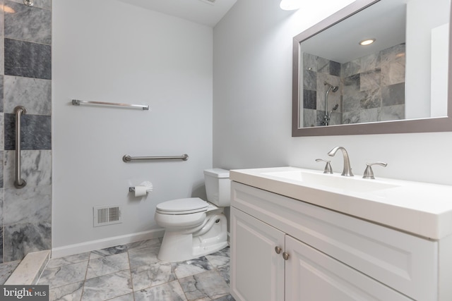 10311 Poe Dr, Manassas, VA 20110 - bathroom featuring marble finish floors, a tile shower, and vanity