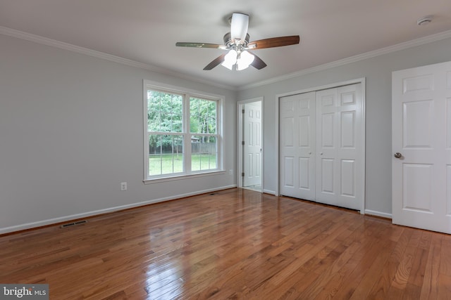 10311 Poe Dr, Manassas, VA 20110 - unfurnished bedroom featuring wood finished floors, crown molding, ceiling fan, and a closet
