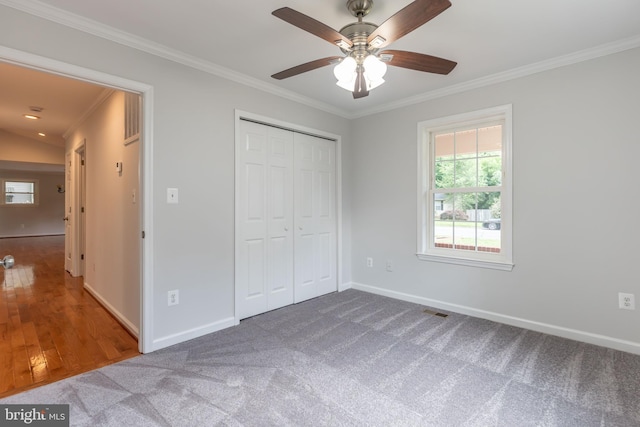10311 Poe Dr, Manassas, VA 20110 - unfurnished bedroom featuring ornamental molding, multiple windows, a closet, carpet floors, and ceiling fan