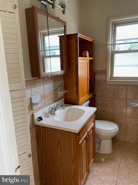 6813 10th Ave, Takoma Park, MD 20912 - half bath with vanity, tile walls, and tile patterned floors