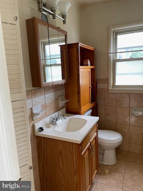 6813 10th Ave, Takoma Park, MD 20912 - half bathroom with vanity, tile walls, and tile patterned floors