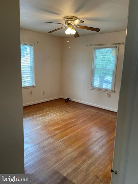 6813 10th Ave, Takoma Park, MD 20912 - empty room featuring plenty of natural light, a ceiling fan, and wood finished floors