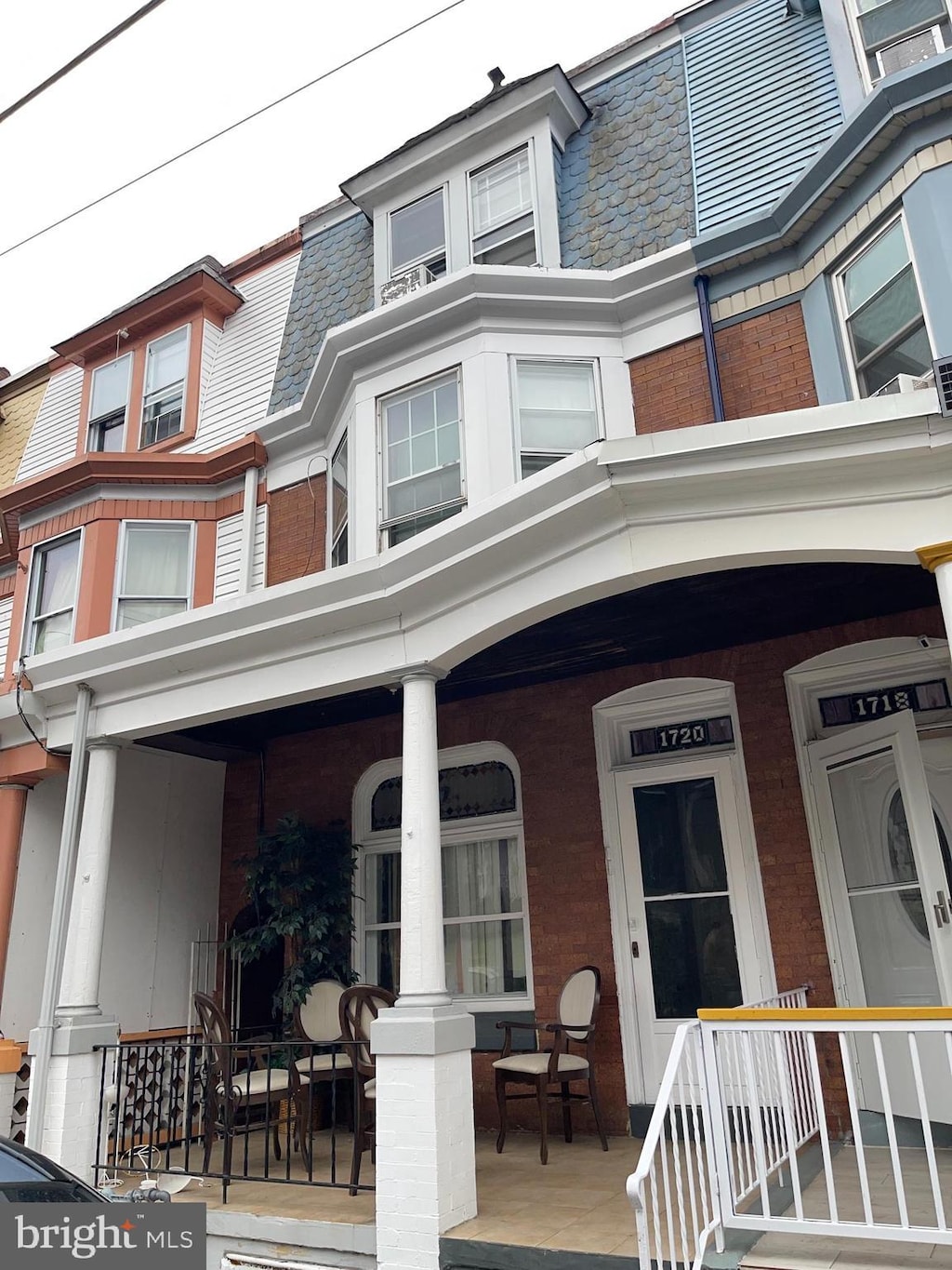 1720 Haak St, Reading, PA 19602 - view of front of home featuring covered porch, brick siding, a high end roof, and mansard roof