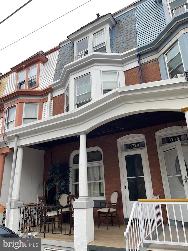 1720 Haak St, Reading, PA 19602 - view of front of home featuring covered porch, brick siding, a high end roof, and mansard roof