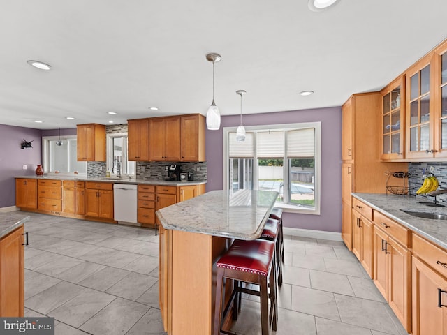 2505 Yellowstone Rd, Cinnaminson, NJ 08077 - kitchen featuring dishwasher, tasteful backsplash, light stone countertops, a breakfast bar, and a kitchen island