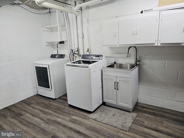 9090 Moonshine Holw Unit C, Laurel, MD 20723 - laundry area featuring separate washer and dryer, cabinet space, concrete block wall, and dark wood-style floors