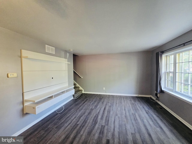 9090 Moonshine Holw Unit C, Laurel, MD 20723 - unfurnished living room featuring dark wood-type flooring and stairway