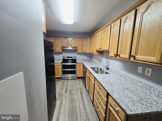 9090 Moonshine Holw Unit C, Laurel, MD 20723 - kitchen featuring double oven range, freestanding refrigerator, light stone counters, light wood-style flooring, and under cabinet range hood