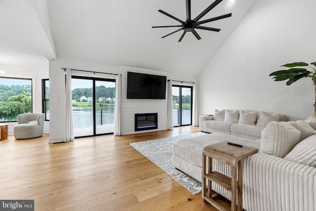 9 W Shore Ct, Landenberg, PA 19350 - living room with high vaulted ceiling, ceiling fan, light wood-style flooring, and a large fireplace