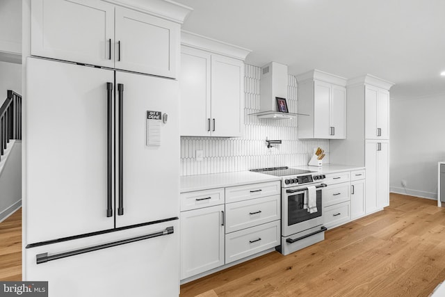 9 W Shore Ct, Landenberg, PA 19350 - kitchen featuring white fridge, electric range, wall chimney range hood, white cabinetry, and backsplash
