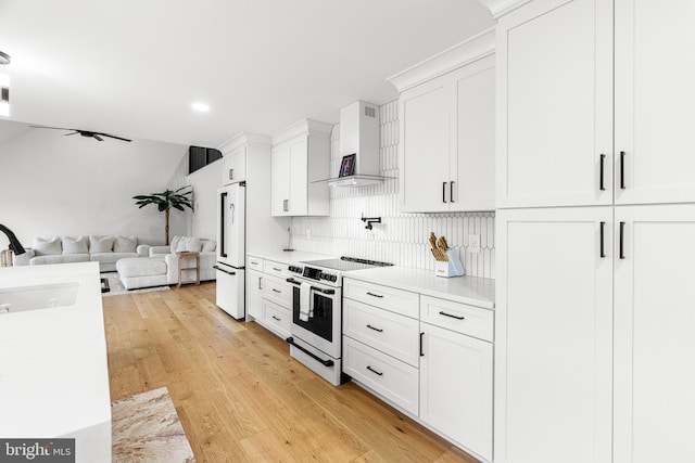 9 W Shore Ct, Landenberg, PA 19350 - kitchen with white appliances, wall chimney exhaust hood, open floor plan, light countertops, and recessed lighting