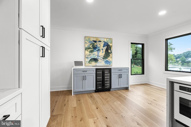 9 W Shore Ct, Landenberg, PA 19350 - bar area featuring beverage cooler, crown molding, light wood-style flooring, and recessed lighting