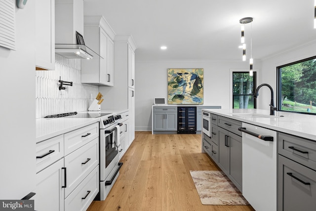 9 W Shore Ct, Landenberg, PA 19350 - kitchen with white appliances, gray cabinets, wall chimney range hood, crown molding, and light wood-style flooring