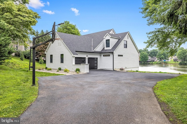 9 W Shore Ct, Landenberg, PA 19350 - view of front facade with driveway, a water view, roof with shingles, a front lawn, and an attached garage