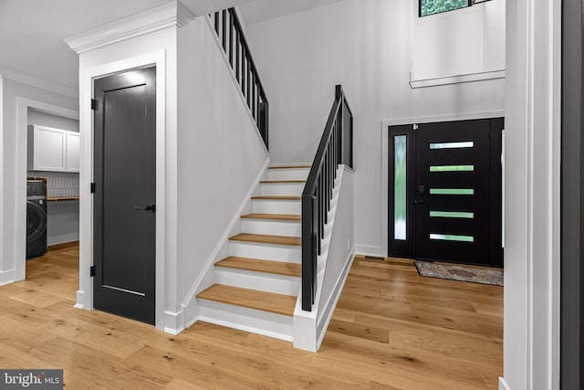 9 W Shore Ct, Landenberg, PA 19350 - foyer entrance with washer / dryer, crown molding, stairway, and light wood finished floors