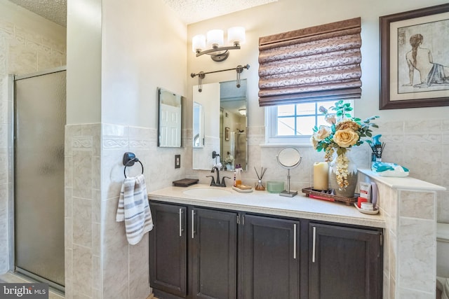 2404 Elfreths Aly, Bensalem, PA 19020 - full bath with tile walls, a shower stall, vanity, a textured ceiling, and wainscoting