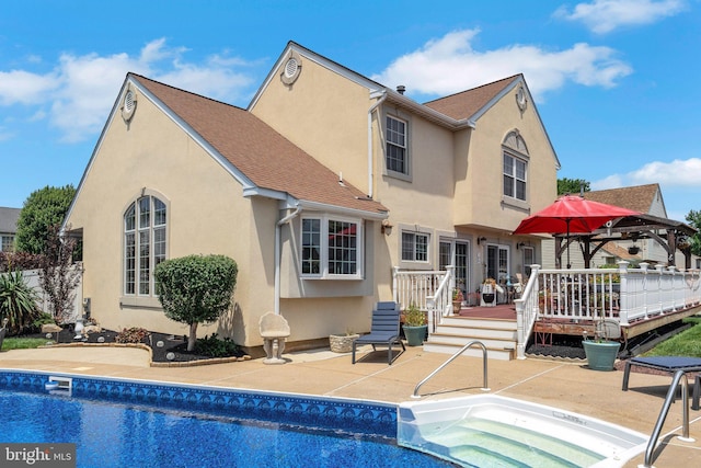 2404 Elfreths Aly, Bensalem, PA 19020 - rear view of property with stucco siding, a deck, an outdoor pool, and a patio area