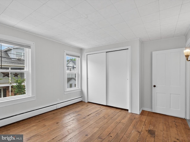 31 W Ferdinand St, Manheim, PA 17545 - unfurnished bedroom with a baseboard heating unit, hardwood / wood-style floors, and a closet