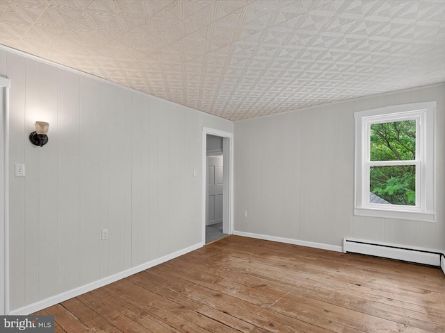 31 W Ferdinand St, Manheim, PA 17545 - unfurnished room with hardwood / wood-style flooring, an ornate ceiling, and a baseboard heating unit