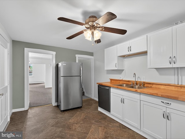 31 W Ferdinand St, Manheim, PA 17545 - kitchen with appliances with stainless steel finishes, butcher block countertops, ceiling fan, white cabinets, and dark stone finish floors