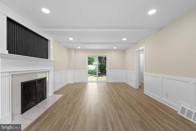 201 E Franklin Ave, Edgewater Park, NJ 08010 - unfurnished living room with wood finished floors, wainscoting, a high end fireplace, recessed lighting, and beamed ceiling
