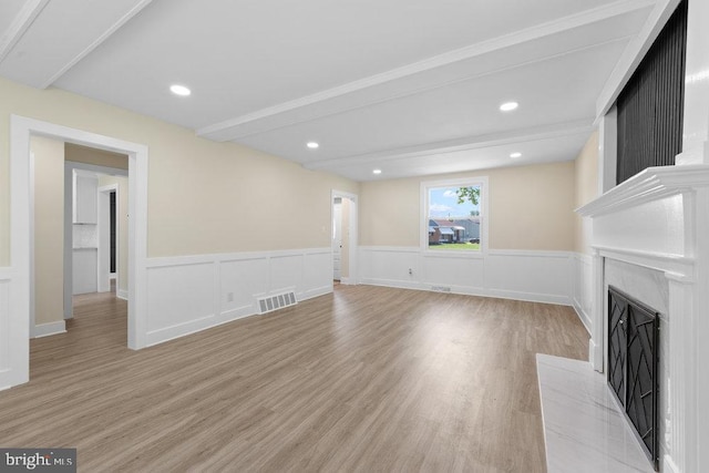 201 E Franklin Ave, Edgewater Park, NJ 08010 - unfurnished living room featuring a fireplace with flush hearth, light wood-style floors, a wainscoted wall, beam ceiling, and recessed lighting