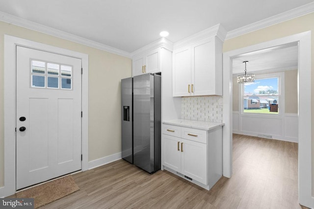 201 E Franklin Ave, Edgewater Park, NJ 08010 - kitchen with stainless steel fridge with ice dispenser, light wood-style floors, plenty of natural light, and ornamental molding