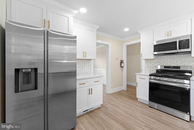 201 E Franklin Ave, Edgewater Park, NJ 08010 - kitchen featuring stainless steel appliances, white cabinetry, backsplash, light wood-style flooring, and crown molding