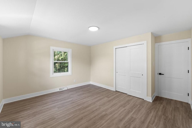 201 E Franklin Ave, Edgewater Park, NJ 08010 - unfurnished bedroom with wood finished floors, a closet, and lofted ceiling