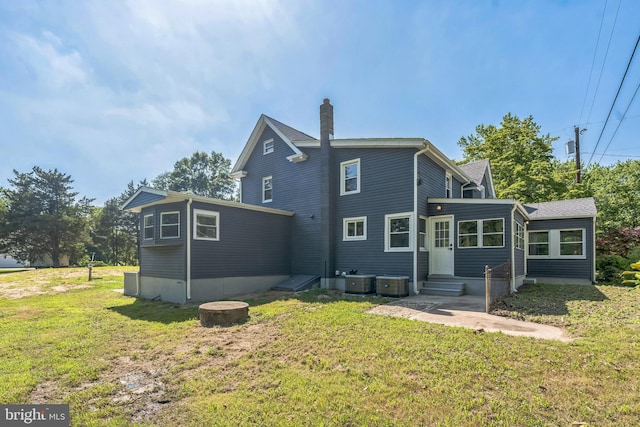 17 Sportsmans Rd, Carneys Point, NJ 08069 - rear view of property featuring a chimney, a yard, and entry steps