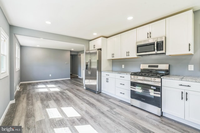 17 Sportsmans Rd, Carneys Point, NJ 08069 - kitchen featuring appliances with stainless steel finishes, light wood finished floors, white cabinets, light stone counters, and recessed lighting