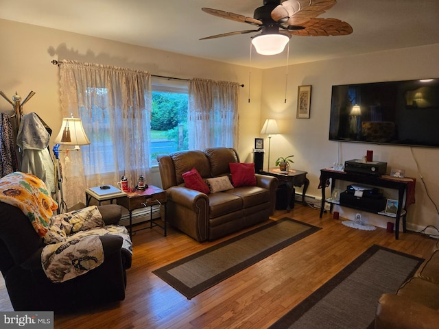 235 S Main St, Quakertown, PA 18951 - living area with wood finished floors, ceiling fan, and baseboard heating