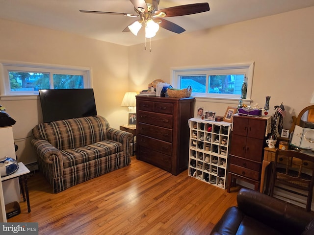 235 S Main St, Quakertown, PA 18951 - living room featuring wood finished floors, a ceiling fan, and a baseboard heating unit