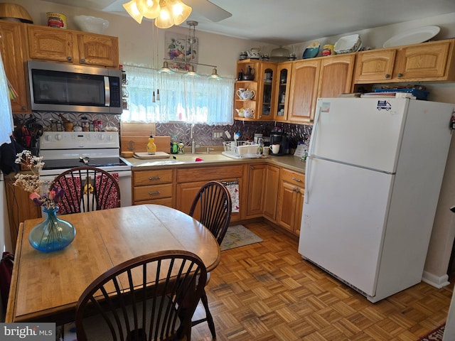 235 S Main St, Quakertown, PA 18951 - kitchen featuring white appliances, light countertops, a ceiling fan, glass insert cabinets, and tasteful backsplash