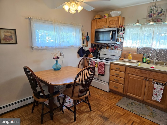 235 S Main St, Quakertown, PA 18951 - kitchen with electric stove, stainless steel microwave, a baseboard radiator, a ceiling fan, and light countertops