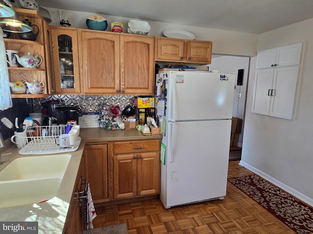 235 S Main St, Quakertown, PA 18951 - kitchen with freestanding refrigerator, glass insert cabinets, and light countertops