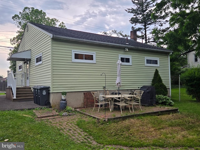 235 S Main St, Quakertown, PA 18951 - back of property featuring a chimney, a lawn, and a patio area