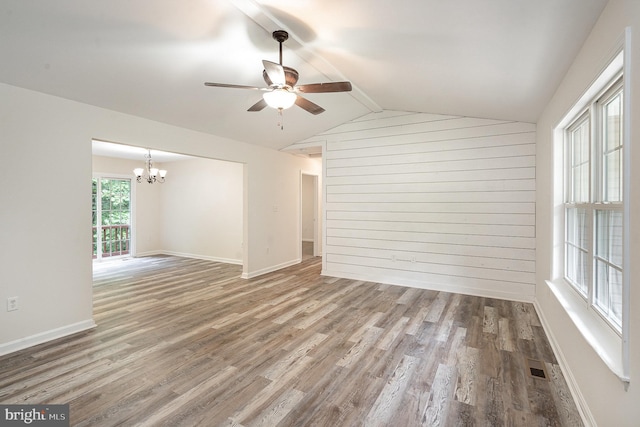 114 Dragoon Dr, Montross, VA 22520 - unfurnished room featuring a chandelier, ceiling fan, wooden walls, wood finished floors, and vaulted ceiling