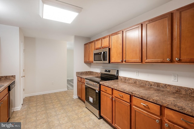 114 Dragoon Dr, Montross, VA 22520 - kitchen featuring appliances with stainless steel finishes, dark countertops, and brown cabinets