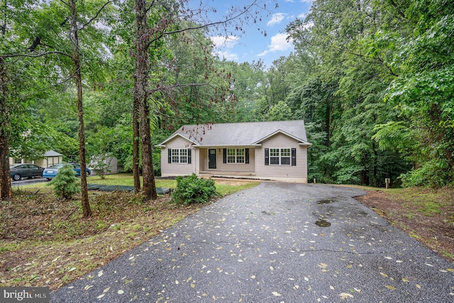 114 Dragoon Dr, Montross, VA 22520 - ranch-style house featuring driveway and a forest view