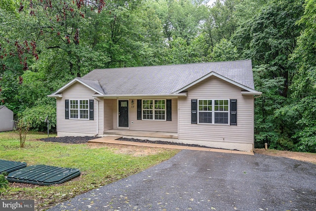114 Dragoon Dr, Montross, VA 22520 - ranch-style house featuring covered porch, a shingled roof, a shed, and a front lawn