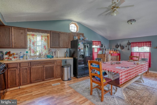 25036 Becks Ln, Georgetown, DE 19947 - kitchen with black appliances, lofted ceiling, light wood-type flooring, light countertops, and ceiling fan