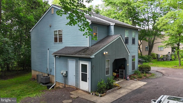 236 Jan Dr, Harleysville, PA 19438 - view of side of property featuring roof with shingles and asphalt driveway